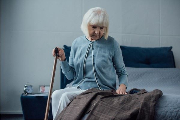 Elderly woman on bed