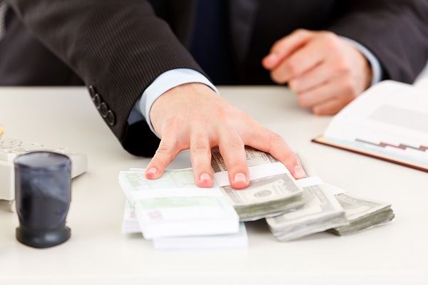 loan officer giving wads of cash