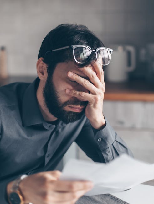 Unhappy man reading divorce papers