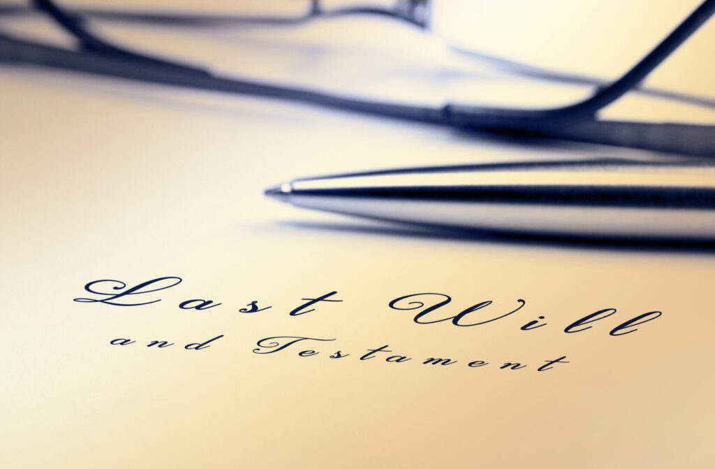 Last will and testament with pen and reading glasses.