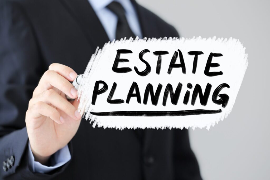 Businessman is writing Estate Planning Business Concept.