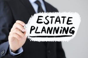 Businessman is writing Estate Planning Business Concept.