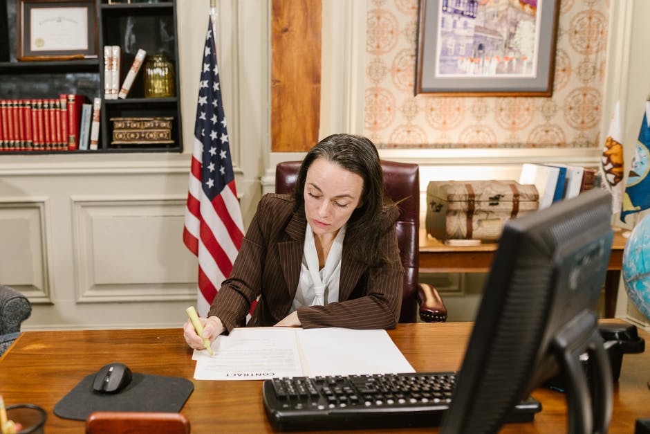 Woman highlighting paper at desk