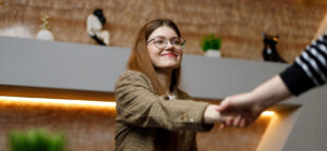 Young white woman shaking hands