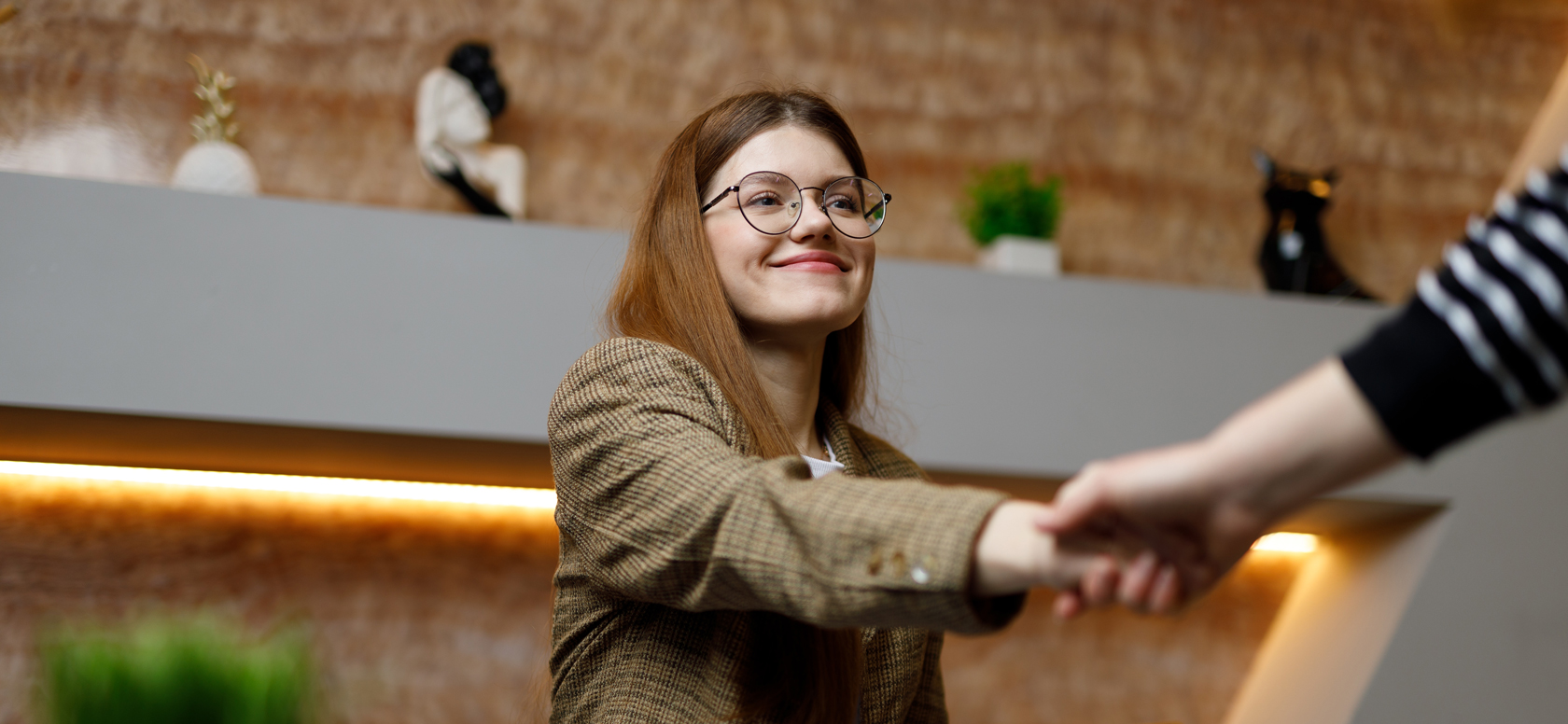 Young white woman shaking hands