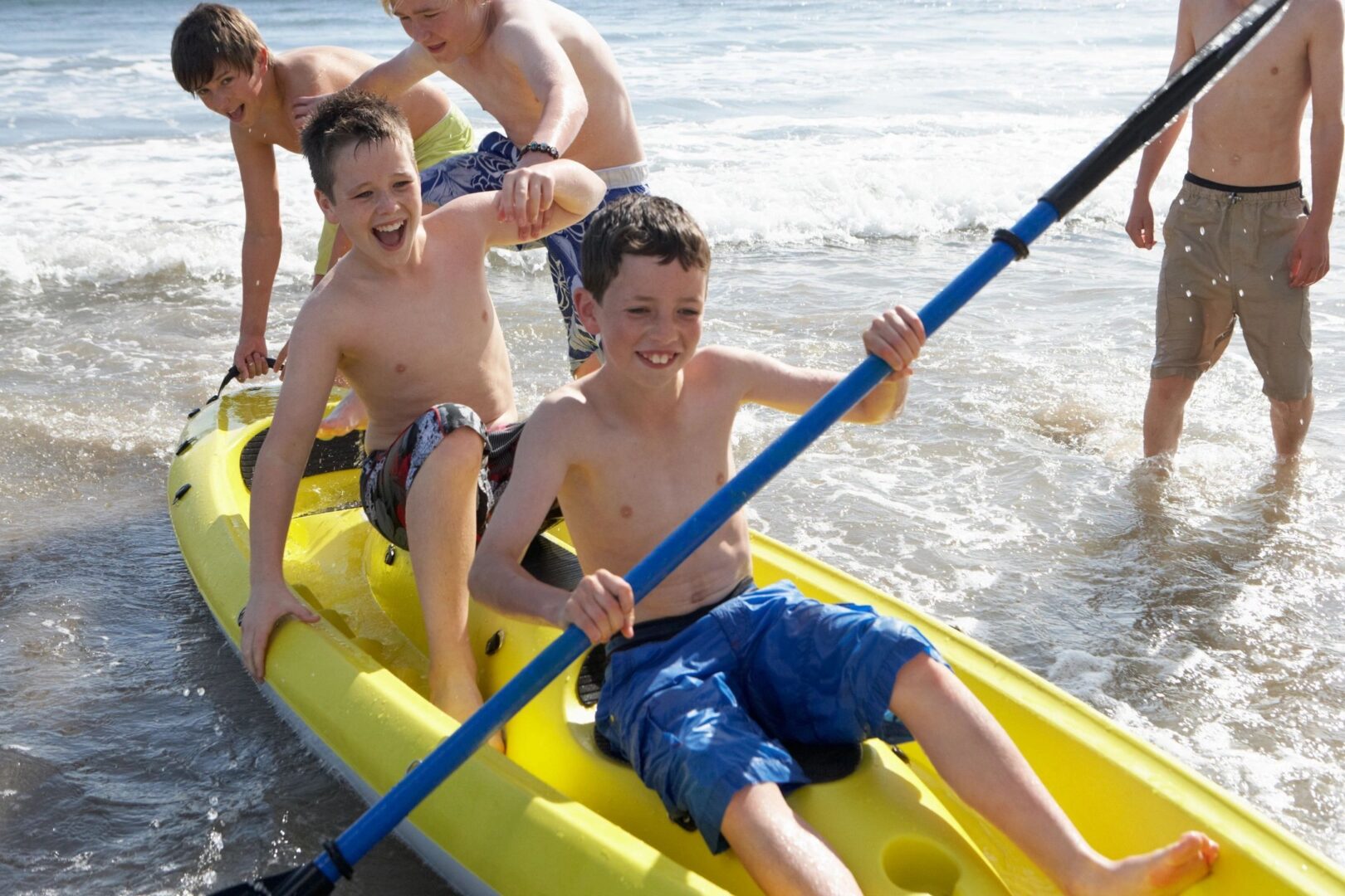 boys in kayak playing in the water