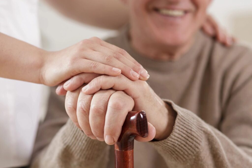 close up of hands on a cane